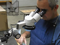 MILCO Waterjet & Wire EDM - Inspection and Quality Assurance - Our friendly staff member inspecting a newly machined part